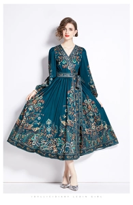 Detail of V-neck paisley wrap dress with long sleeves and adjustable waist tie belt