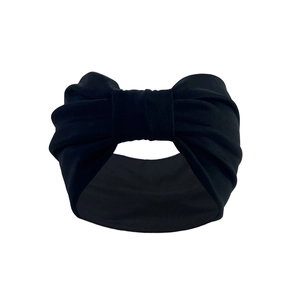 Elastic bohemian wide sports headband in black fabric with a stylish knotted bow design