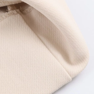 Macro shot of off-white canvas fabric showing detailed twill texture and stitching