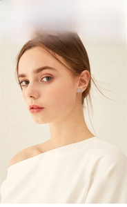 Close-up of classic six-prong moissanite stud earring worn on model's ear