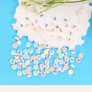 Colorful zodiac symbol beads on white tray for DIY bracelets and jewelry making
