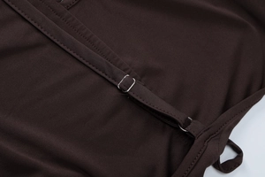 Detail view of adjustable shoulder straps with metal buckle on a brown jumpsuit