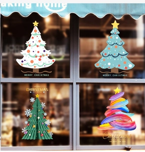 Detail view of four artistic Christmas tree window stickers for festive holiday glass decor