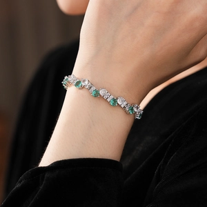 Close-up of sparkling green zircon twisted buckle bracelet on a model wrist