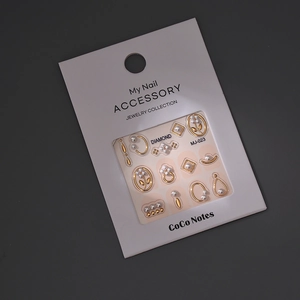 Detail view of MJ-023 nail art set with pearls, gold frames and floral rhinestones