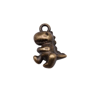 Close-up of vintage bronze alloy dinosaur pendant with detailed metal texture and finish