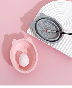 Detailed view of pink and grey silicone makeup brush cleaners with cat ear design
