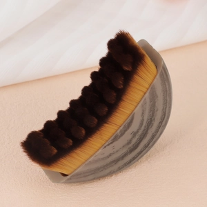 Curved foundation brush with marble handle and brown gradient bristles for face contouring