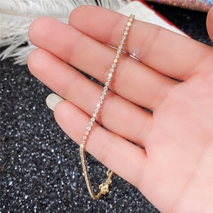 Close-up of rose gold tennis necklace featuring pave-set AAA cubic zirconia stones