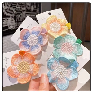 Set of 5 embroidered floral hair clips in pastel colors on white display card