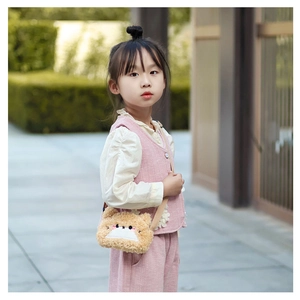 Close-up of cute brown plush bear crossbody bag with embroidery and ears for little girls