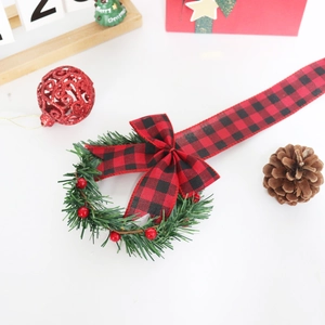 Christmas cabinet ribbon wreath with red berries and black-red buffalo plaid bow tie