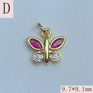Macro shot of 9.7x9.1mm butterfly charm with red stones and white zirconia detail