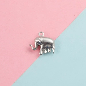 Polished silver elephant pendant charm for DIY jewelry making on soft pastel background