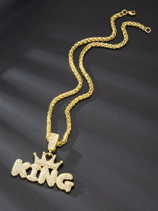 Detail of gold hip hop necklace featuring a crystal-encrusted crown and KING letter pendant