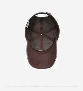 Detail view of the brown baseball cap interior with reinforced seams and embroidery