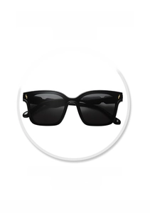 Detail of black oversized sunglasses featuring a stylish golden lightning metal decoration