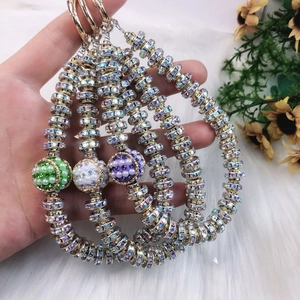 Detailed view of handmade beaded phone charms with sparkling rhinestones and lobster clasp