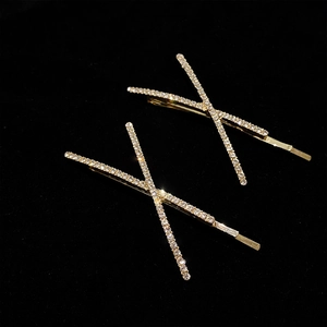 Pair of minimalist X-shaped gold hair clips with sparkling rhinestones for women