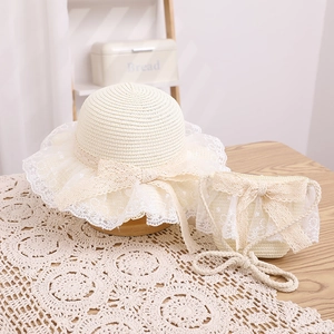 Detail of children's straw hat and matching bag with elegant lace and mesh bow