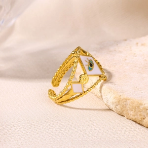 Detail of gold evil eye open ring with blue enamel and triple layer beaded band