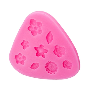 Pink silicone mold featuring mini flower and leaf shapes for fondant and clay crafts