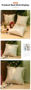 Detail of silver snowflake and Merry Christmas tree patterns on plush holiday pillow cover
