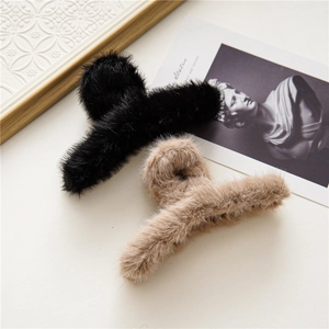 Detailed view of plush faux fur hair claw clips in black and khaki for autumn winter