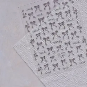 Detail of MS-658 3D embossed nail stickers with black ribbon bows and ethereal text