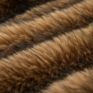 Macro view of plush brown and black striped faux fur texture with soft glossy finish