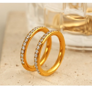 Close-up of dual gold rings featuring sparkling cubic zirconia in a modern stackable style