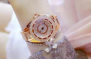 Close-up of luxury rose gold women's watch featuring sparkling rhinestones on the wrist