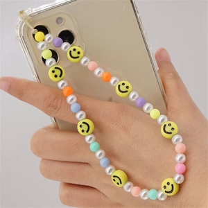 Detailed view of handmade colorful phone strap with smiley face beads and pearls
