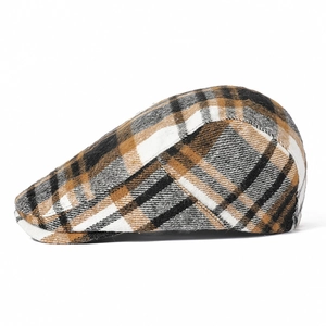 Detail shot of the vintage brown plaid pattern and texture on this stylish newsboy cap