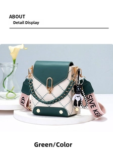 Close-up of contrast green stitching bag with gold U-lock and bear pendant detail
