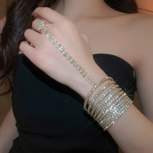 Detailed close-up of a multi-layer rhinestone gold slave bracelet and ring set