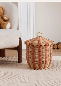 Detail of striped circus tent storage basket featuring a golden star handle on top