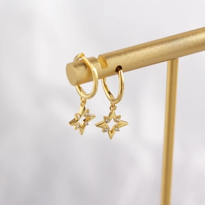 Macro view of gold S925 sterling silver star drop earrings with sparkling zircon stones