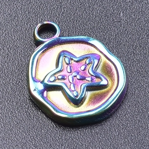 Macro shot of a star-patterned metal pendant with iridescent rainbow electroplated finish