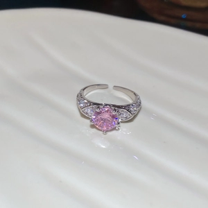 Detail shot of the pink zircon oval ring with a diamond-studded band and adjustable opening