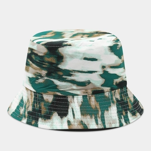 Detail of double-sided bucket hat featuring graffiti camo print and reinforced stitching