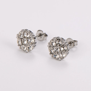 Macro detail of plum blossom stud earrings with silver metal and clear faceted crystals