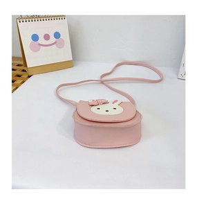 Close-up of pink children's crossbody bag with rabbit ears and cute bow detail