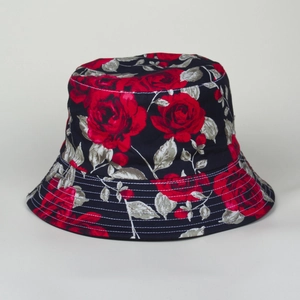 Detailed view of red rose floral print and stitching on dark cotton bucket hat