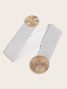 Elastic silver waist belt with round gold metal buckles on a clean beige background