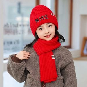 Close-up of red knit hat and scarf set for kids with NICE letter embroidery detail