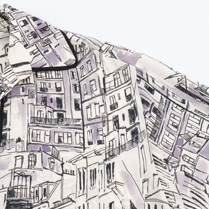 Close-up of contrast piped collar and purple architectural print on lightweight shirt
