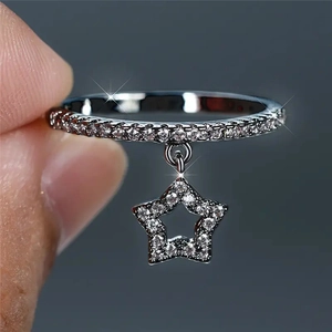 Macro shot of silver ring with star pendant and micro-pave cubic zirconia stones