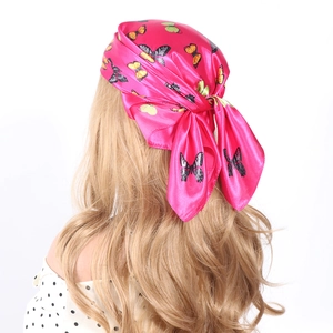Elegant 60cm pink silk scarf with butterfly print worn as a stylish headband for women