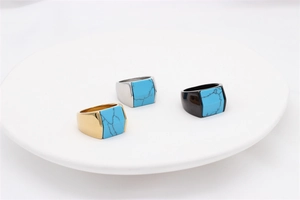 Three men's signet rings with blue turquoise stone in gold, silver, and black finishes